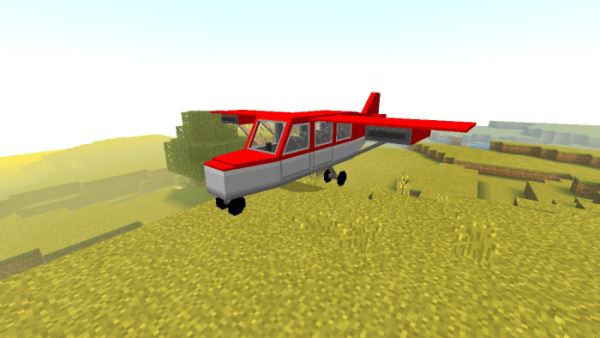 Красно-белый самолет на траве
